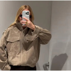Stand collar suede bomber jacket detail on a person