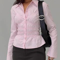 Person wearing a pink striped shirt with a black bag over one shoulder on a gray background