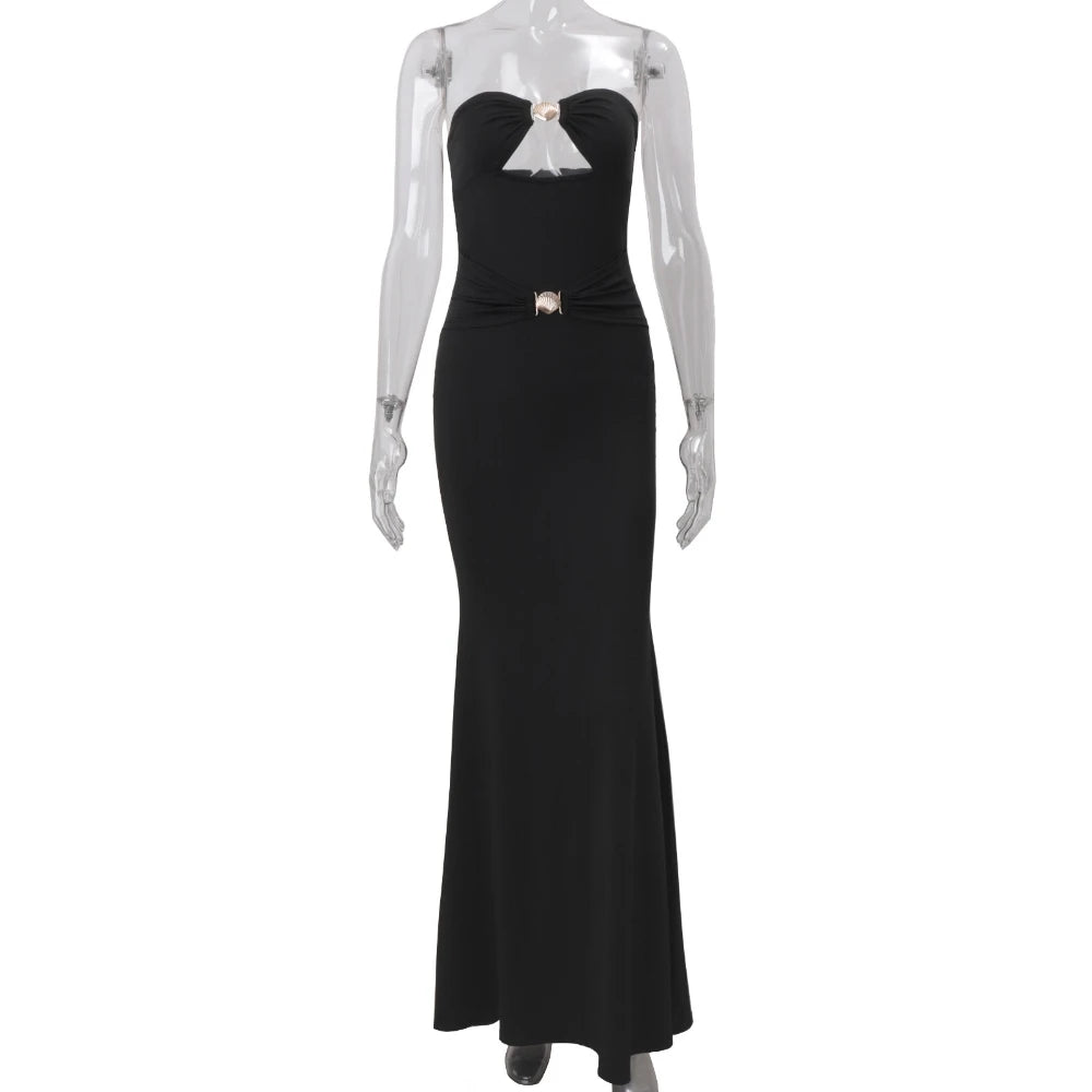 Black evening gown on a mannequin against a white background