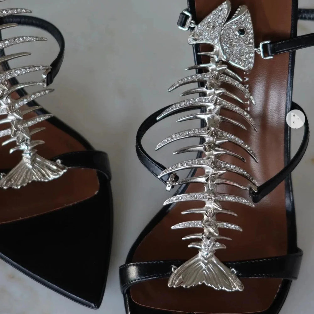 Close-up of fishbone embellishment on stiletto heels