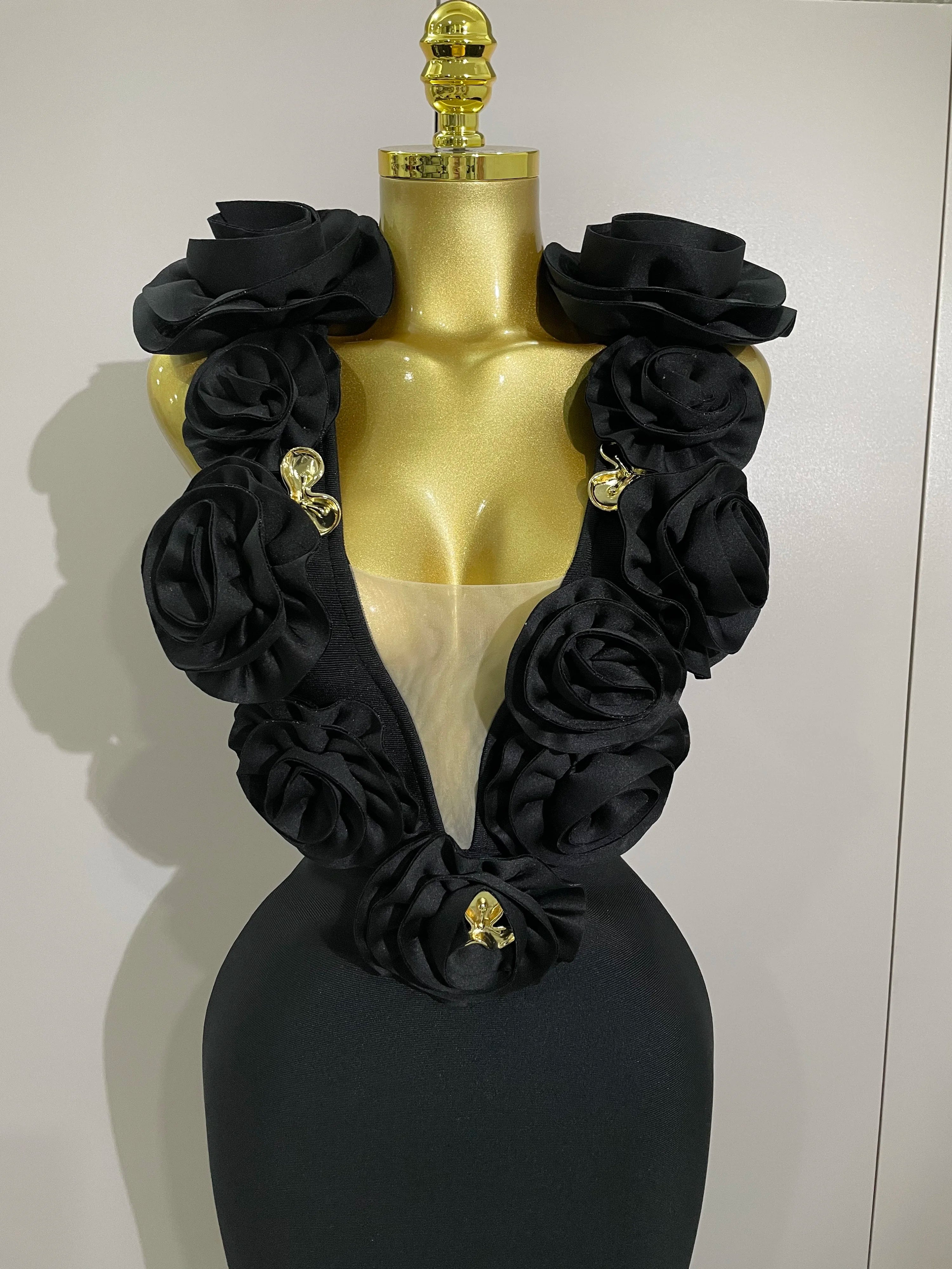 Black floral scarf on a mannequin with a plain background