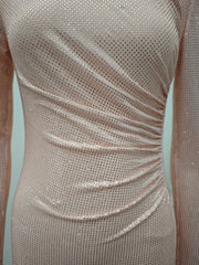 Close-up of a silver sequin dress on a light blue background