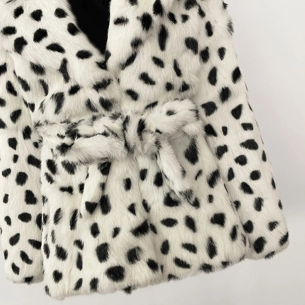 White fur coat with black spots on a white background