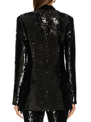 Black sequin blazer worn by a person on a white background