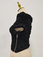 Black textured dress on a mannequin with a plain background