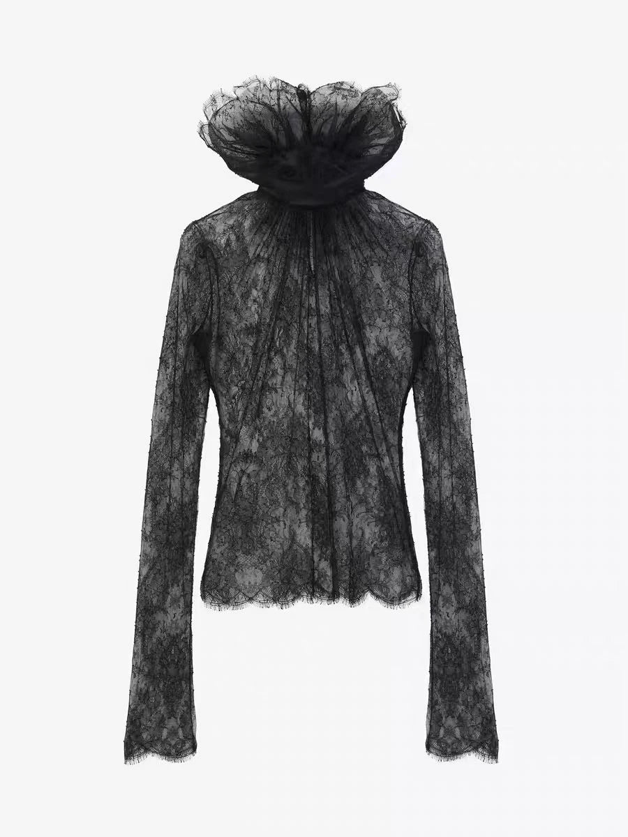 Black lace top with a sheer overlay on a white background