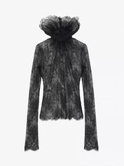 Black lace top with a sheer overlay on a white background