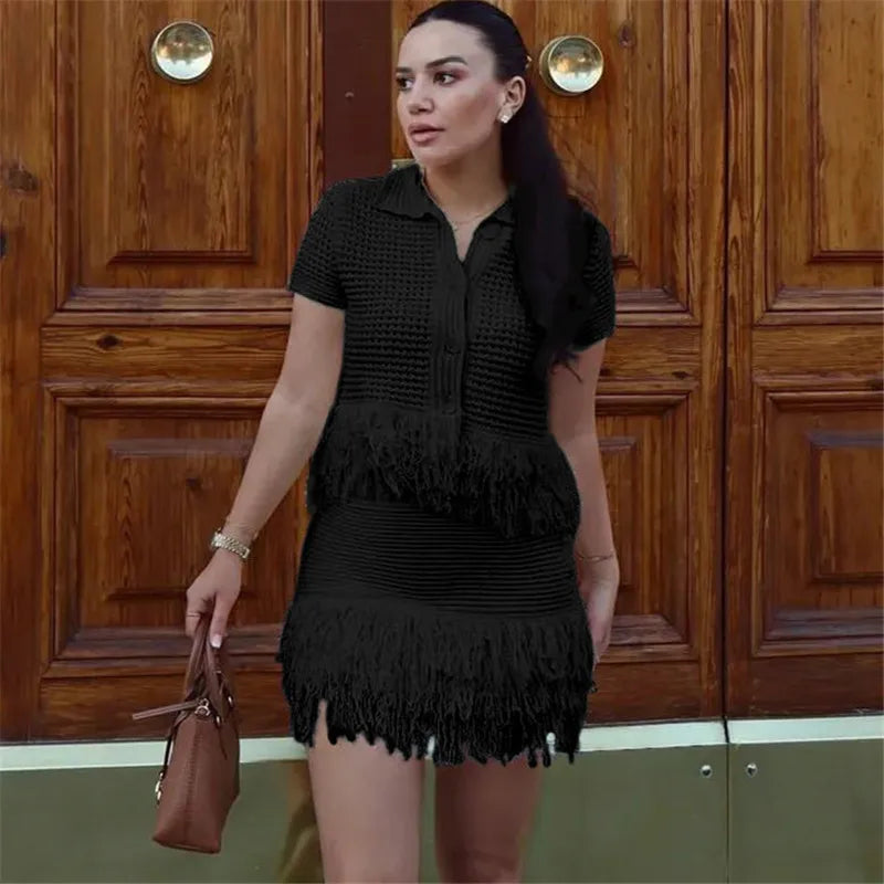 Woman in a black dress standing in front of wooden doors