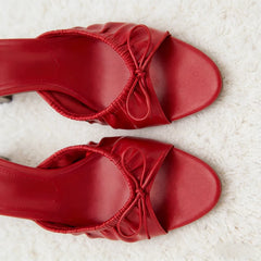 Top down view of red bow detail stiletto heel slides