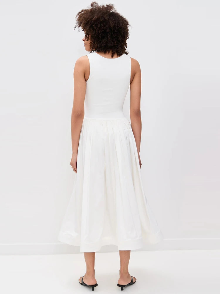 Woman wearing a white dress on a plain background