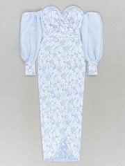 Light blue floral dress with puffed sleeves on a gray background