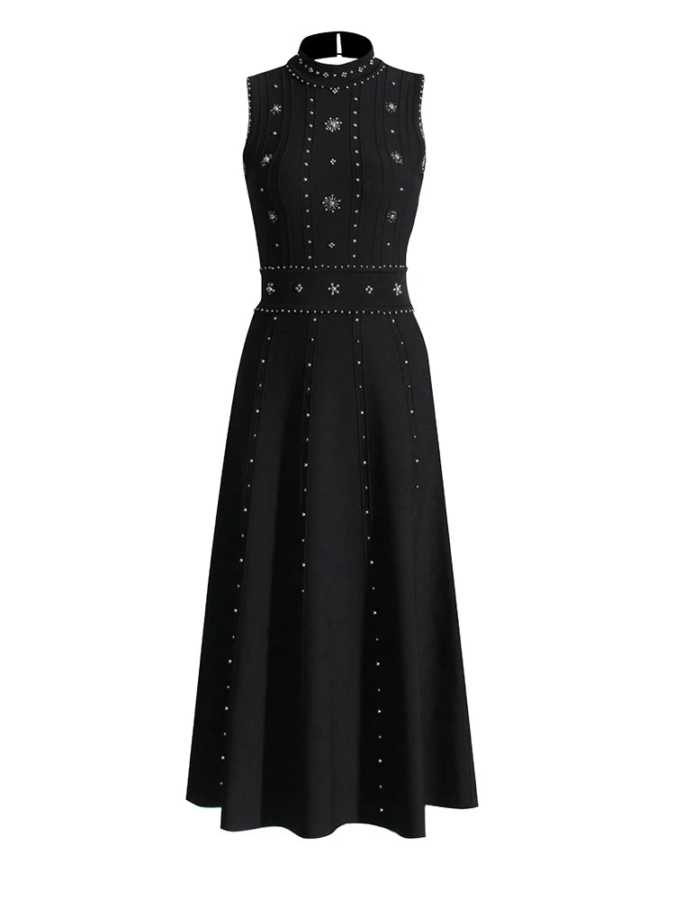 Black dress with silver embellishments on a white background
