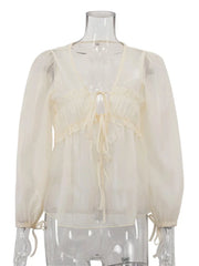 Cream-colored blouse with long sleeves on a mannequin against a white background