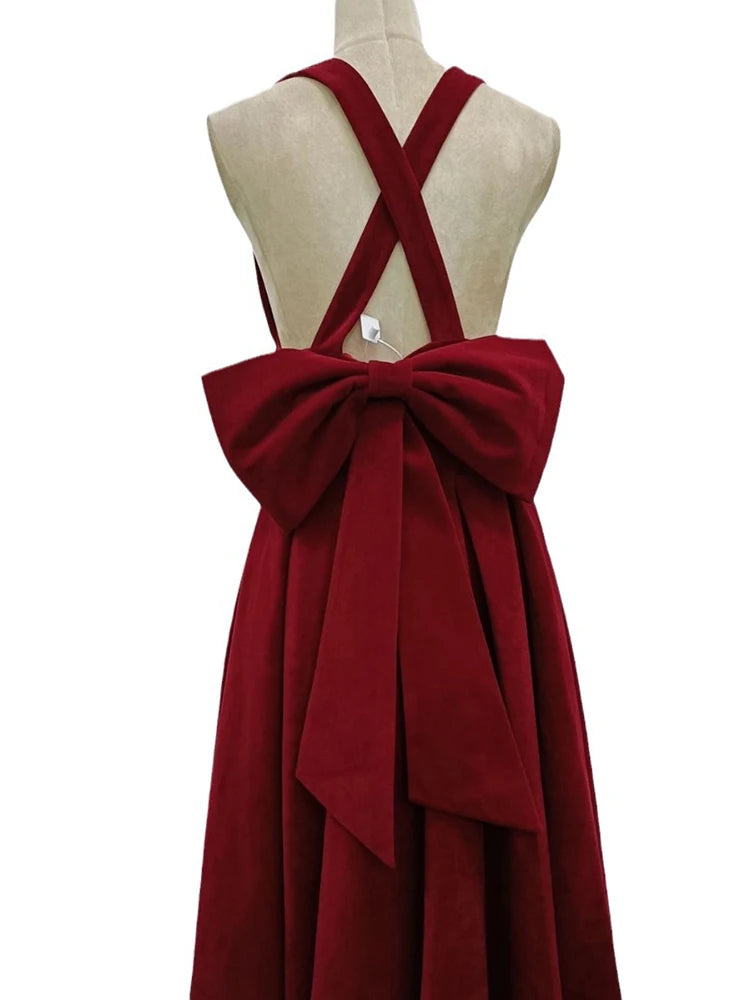 Red dress with a large bow on a mannequin against a white background