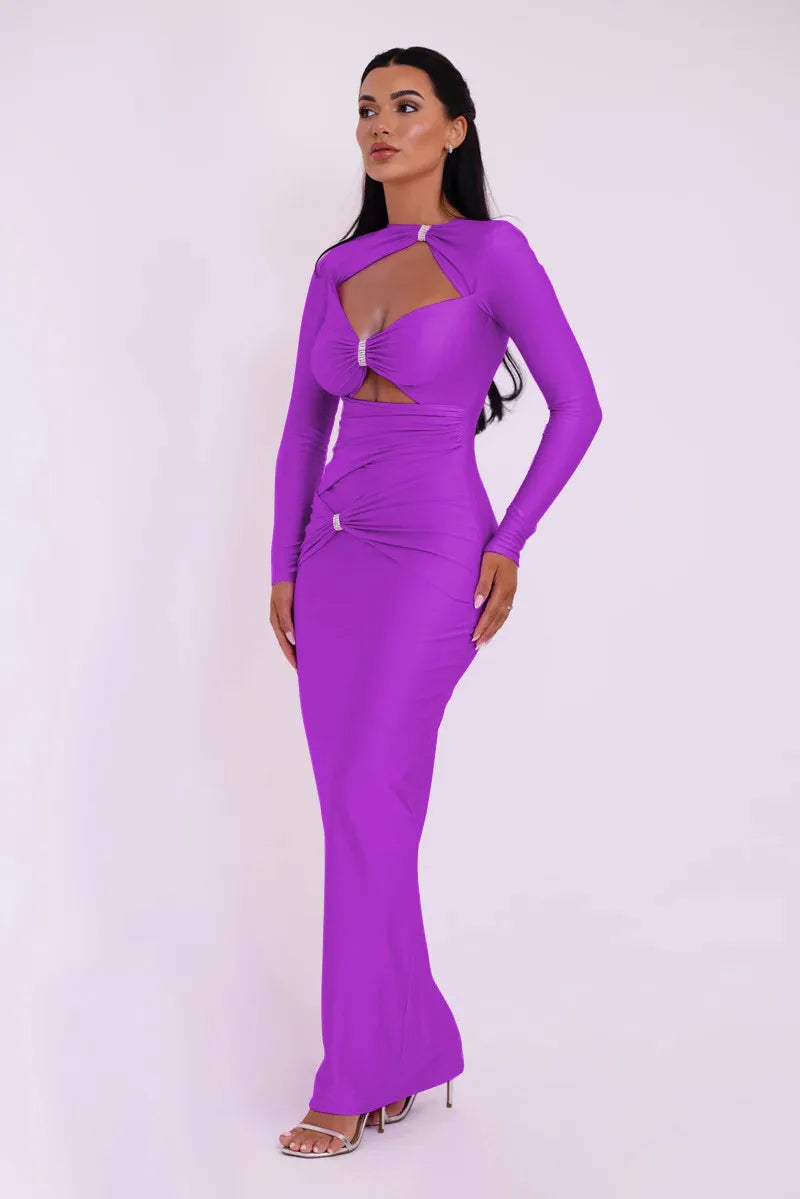 Woman wearing a vibrant purple dress with sheer cutouts on a white background