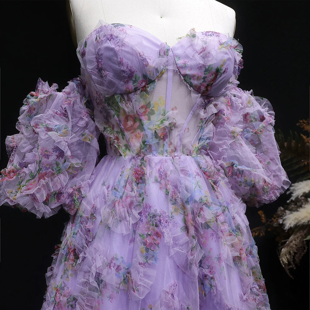 Floral dress with ruffled sleeves on a mannequin against a dark background