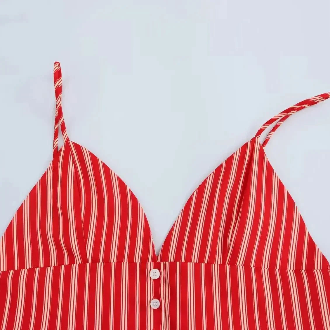 Red and white striped bikini top on a light blue background