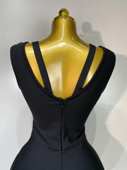 Black dress on a gold mannequin against a white background