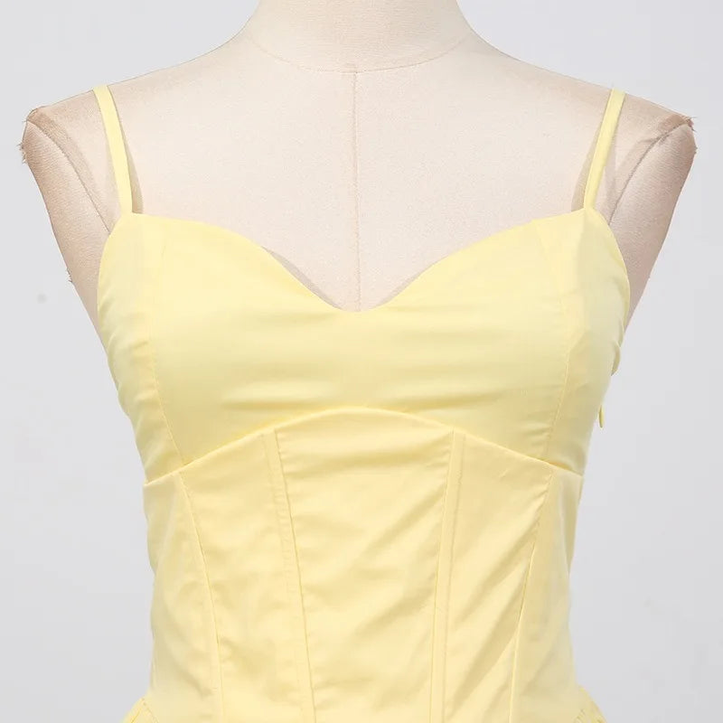 Yellow dress on a mannequin against a light gray background