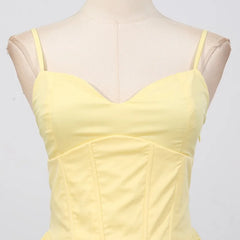 Yellow dress on a mannequin against a light gray background