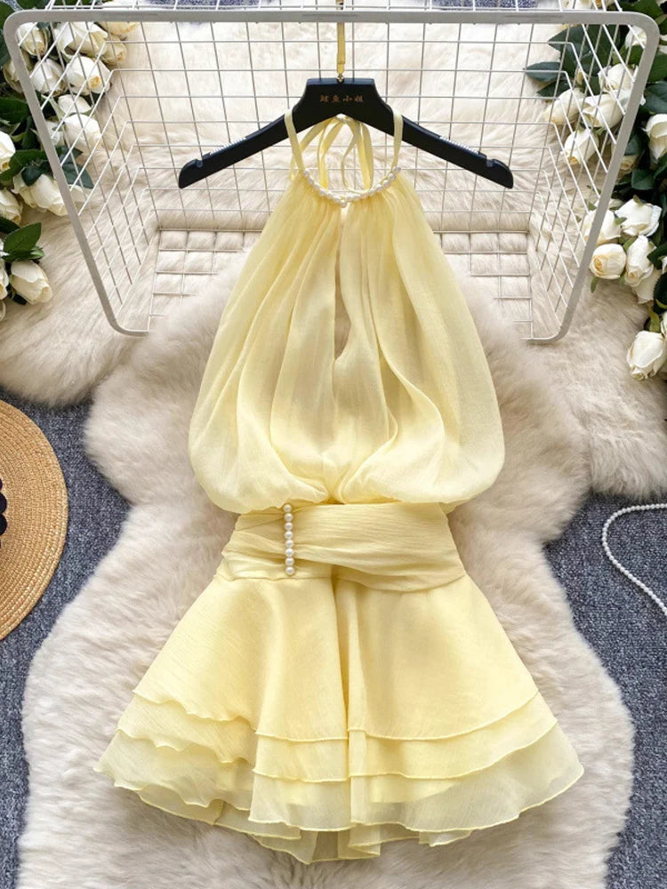Yellow dress on a hanger with a white floral background