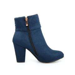 Blue ankle boot with a gold zipper on a white background