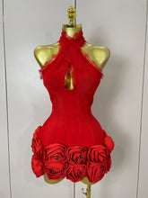 Red dress with floral details on a mannequin against a white background