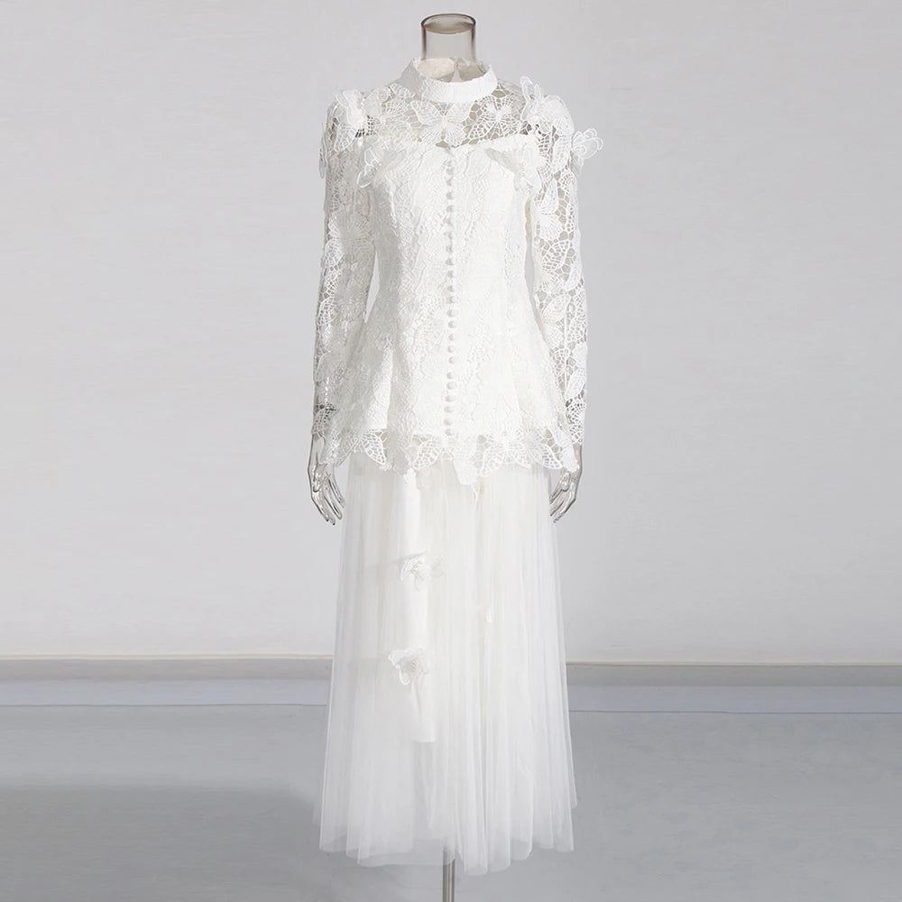 White lace dress on a mannequin against a plain background