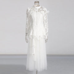 White lace dress on a mannequin against a plain background