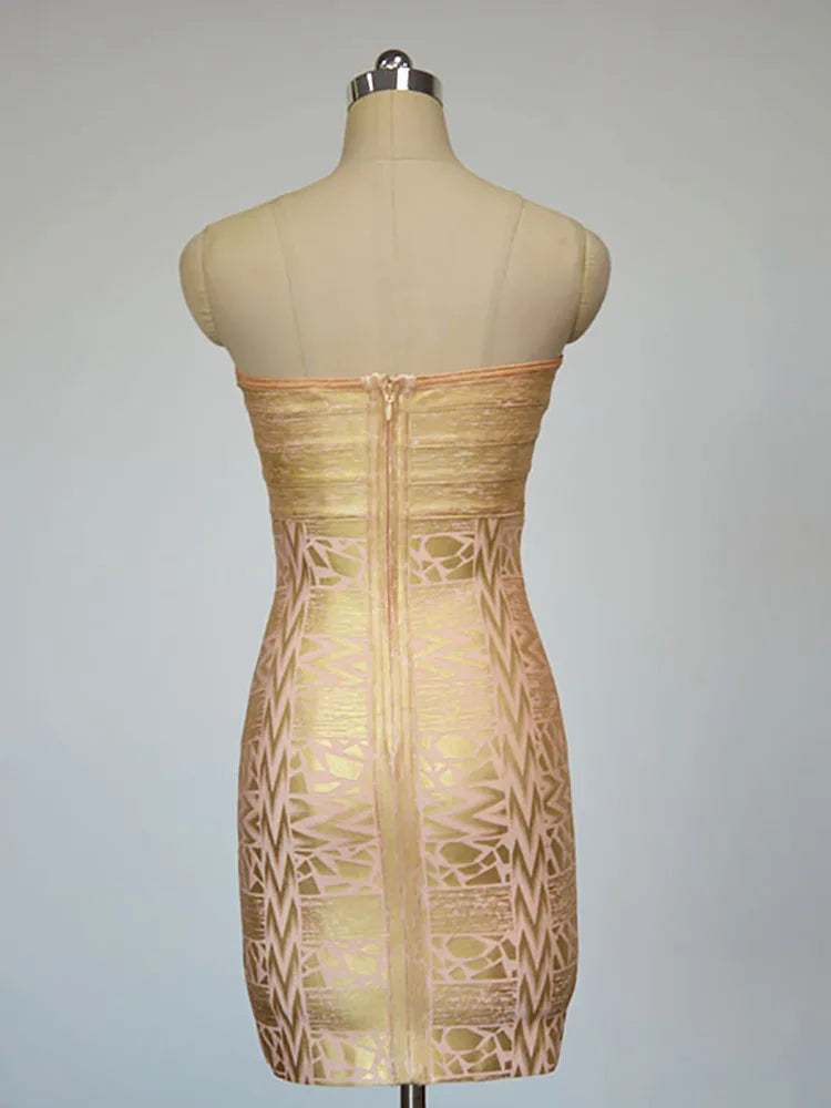 Gold strapless dress with geometric pattern on a mannequin against a gray background