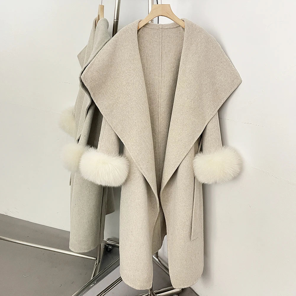 Beige wool blend coat with white fur trim, open front.