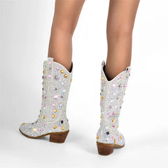 Silver glitter cowboy boots with colorful gemstones on a white background