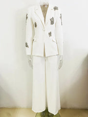 White suit with decorative elements on a mannequin against a plain background