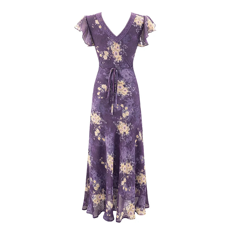 Back view of a purple floral print maxi dress with a tie waist.