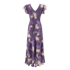 Back view of a purple floral print maxi dress with a tie waist.