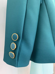 Close-up of gold-button detail on a gradient ombre blazer sleeve