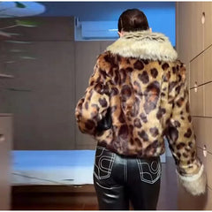 Person wearing a leopard print jacket with white fur trim in an indoor setting.