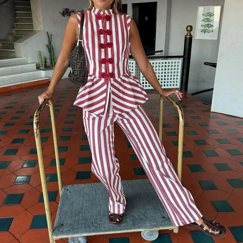 Model wearing the striped peplum top and matching striped trousers