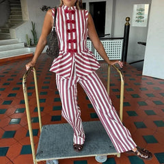 Model wearing the striped peplum top and matching striped trousers