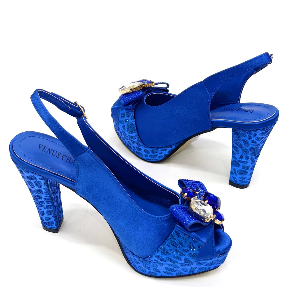 Blue high-heeled shoes with decorative elements on a white background