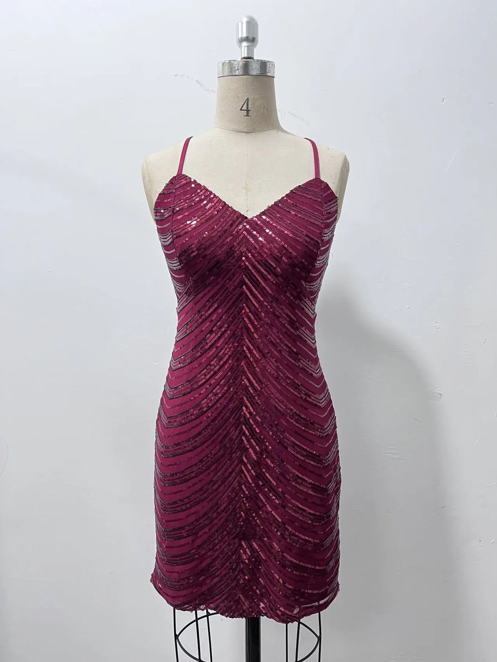 Magenta sequin dress on a mannequin against a white background