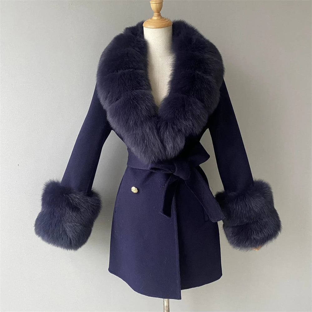Navy blue coat with fur accents on a mannequin against a plain background