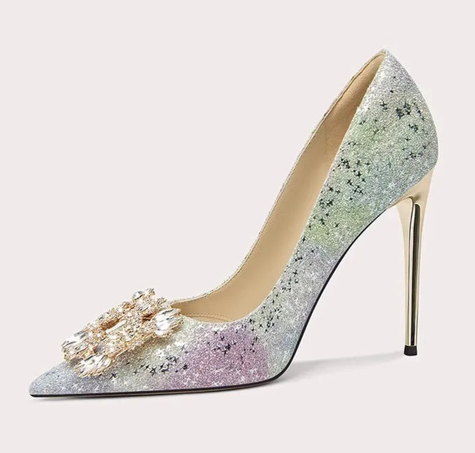 High-heeled shoe with glittery design and decorative element on a light gray background