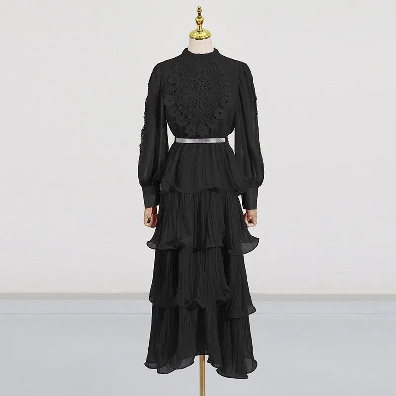 Black dress with intricate detailing on a mannequin against a white background