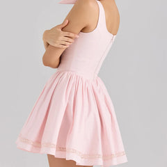 Pink dress with lace trim on a gray background