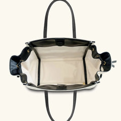 Black handbag with white interior on a white background