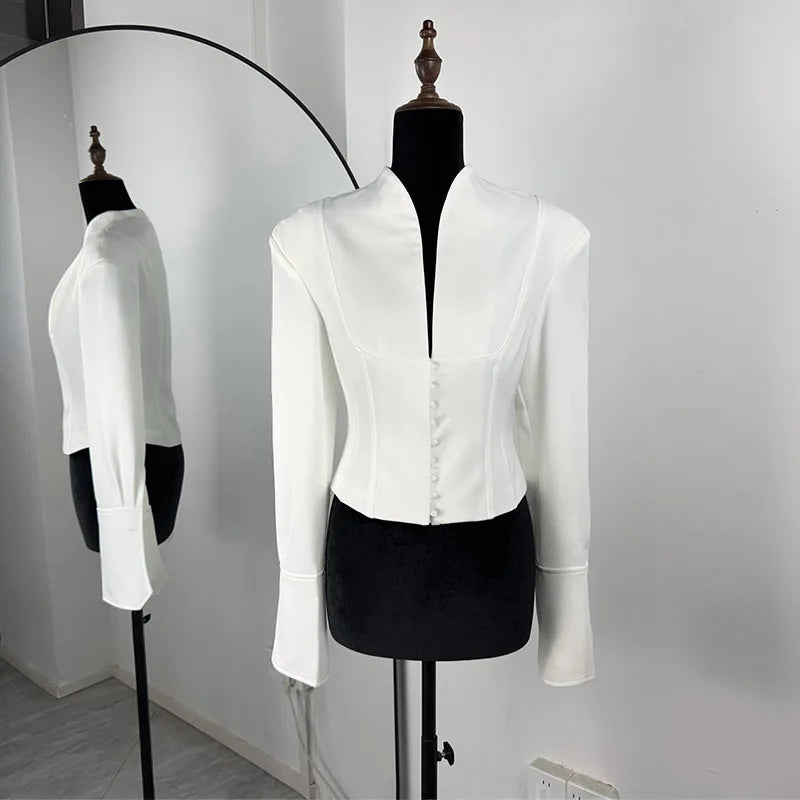 White blazer on a mannequin with a mirror reflection against a white background