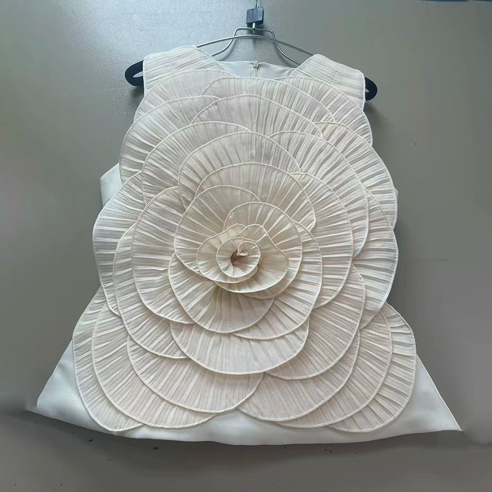 White floral top against a plain background