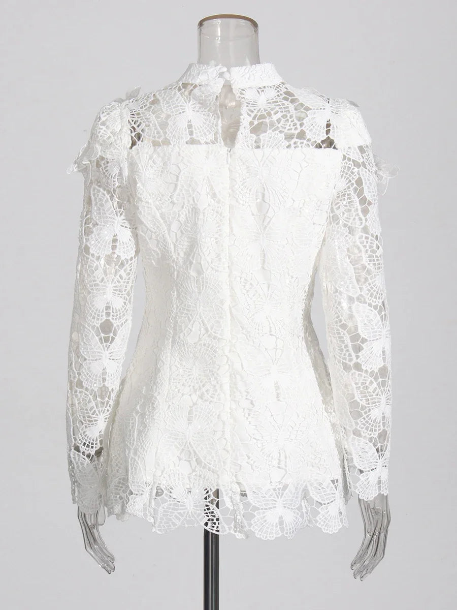 White lace blouse on a mannequin against a white background