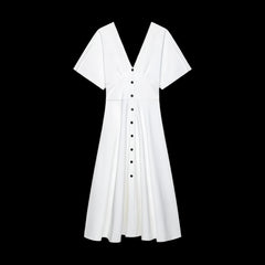 White dress with black buttons on a black background